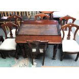 A Victorian mahogany wind out dining table with extra leaf, raised on four turned legs with