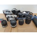A collection of cameras to include a Yashica FR1 camera, a Praktica MTL5B camera and various