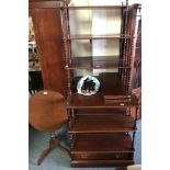 Three mahogany adjustable wall shelves, with turned supports and an oval tilt top occasional