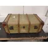 A wood bound green canvas travelling trunk, named A. Hamilton-Smith with period railway labels,