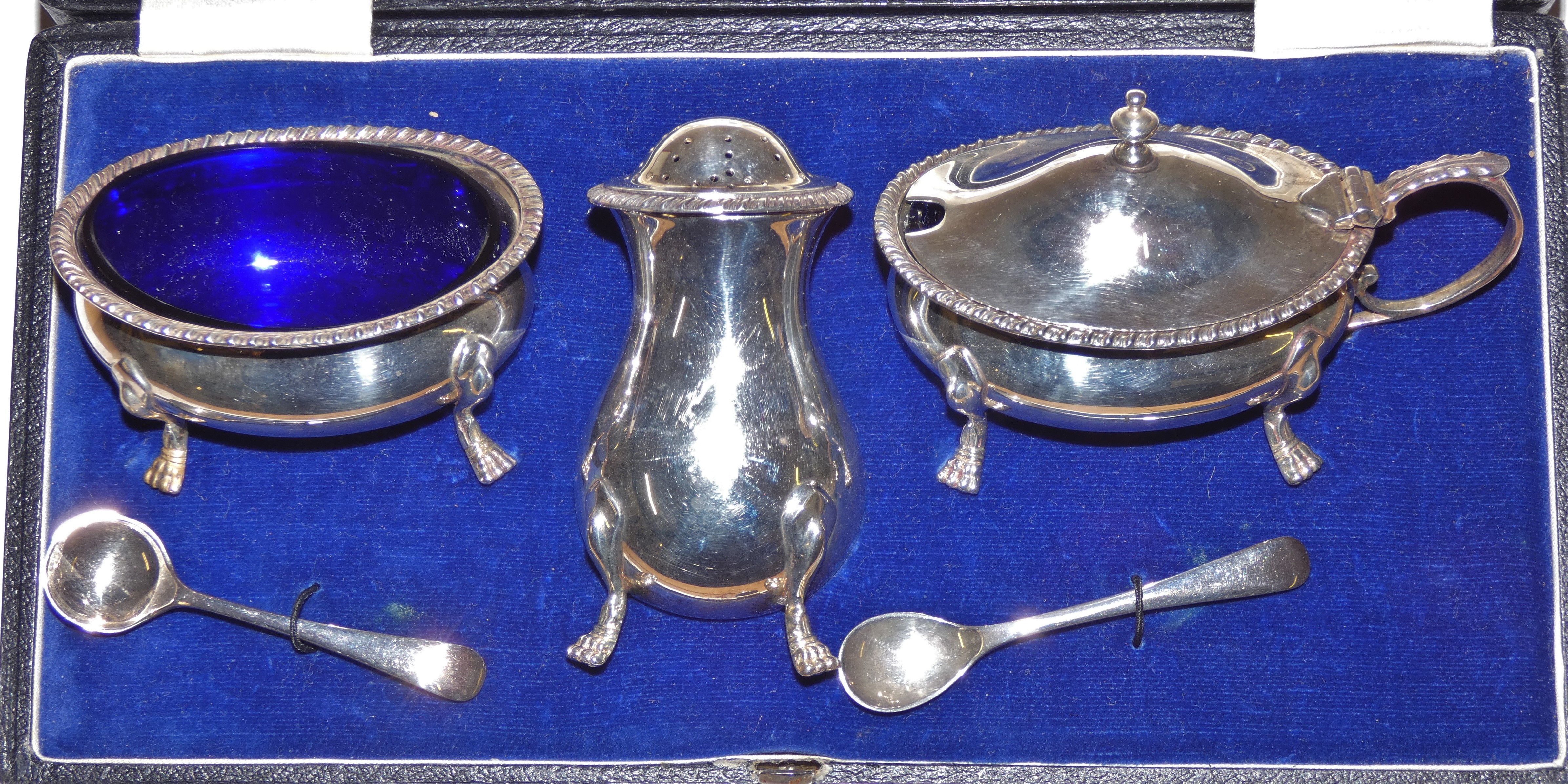 A silver three piece cruet set by Walker and Hall, London 1936 of baluster form, with gadrooned