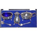 A silver three piece cruet set by Walker and Hall, London 1936 of baluster form, with gadrooned