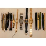 A 1953 coronation propelling pencil, various fountain and ball point pens and wristwatches