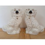 A pair of white Staffordshire dogs, with gilt decoration, 31 cm.