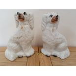 A pair of white Staffordshire dogs, 24 cm.
