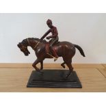 A painted brass model of a mounted jockey, 32cm lacking on stirrup.