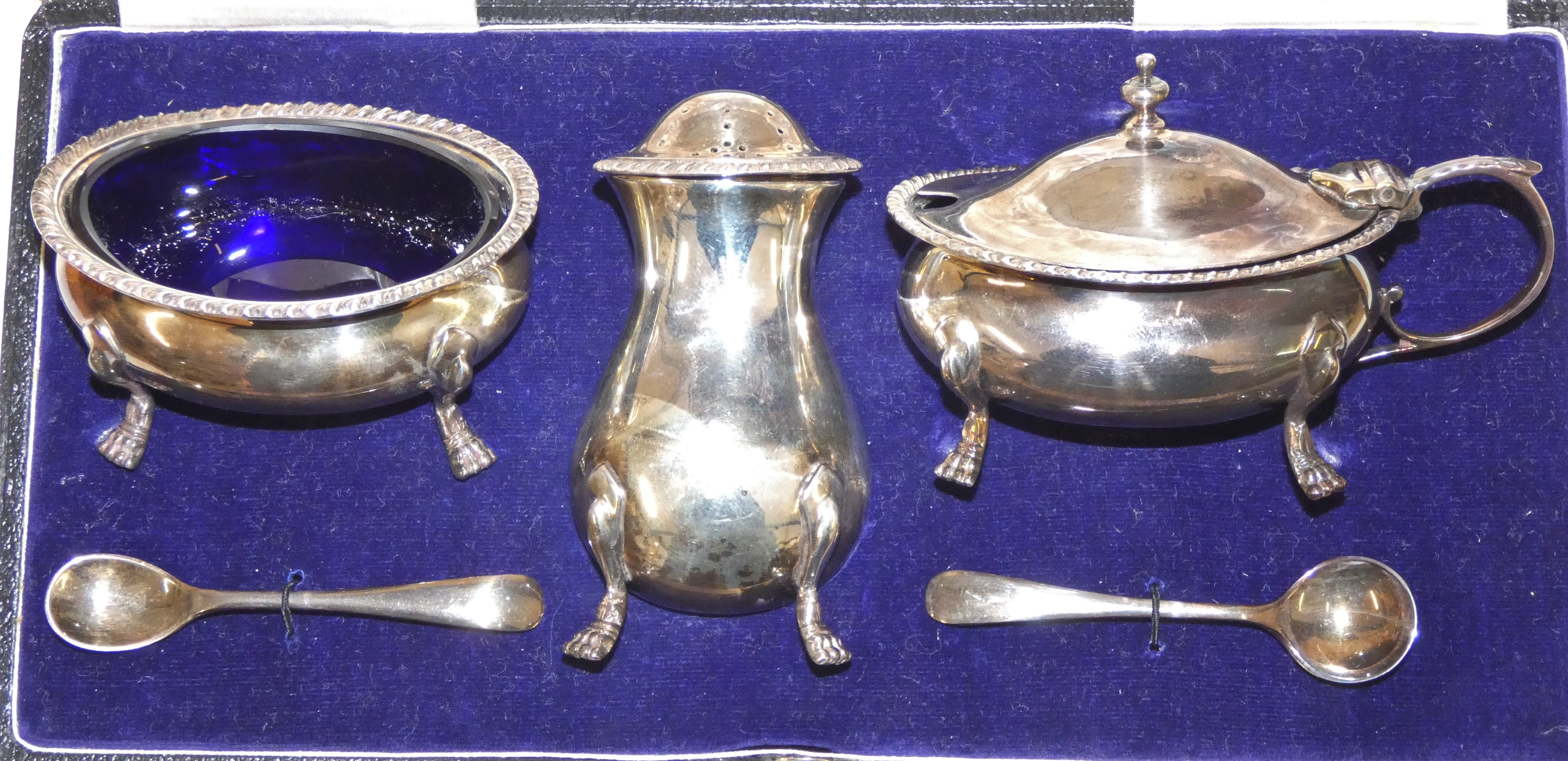 A silver three piece cruet set by Walker and Hall, London 1936 of baluster form, with gadrooned