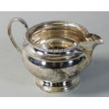 A silver cream jug, Birmingham 1925, of baluster form with gadrooned border, 3 oz.