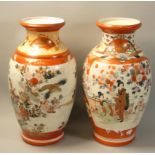 A Japanese pair of Satsuma vases, one with two panels decorated with peafowl and Geisha girls in