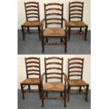 A George III set of six Lancashire style oak wavy ladder back dining chairs, two carvers and four