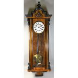 A Victorian Vienna style wall clock, the white enamel two part dial with Roman numerals, the