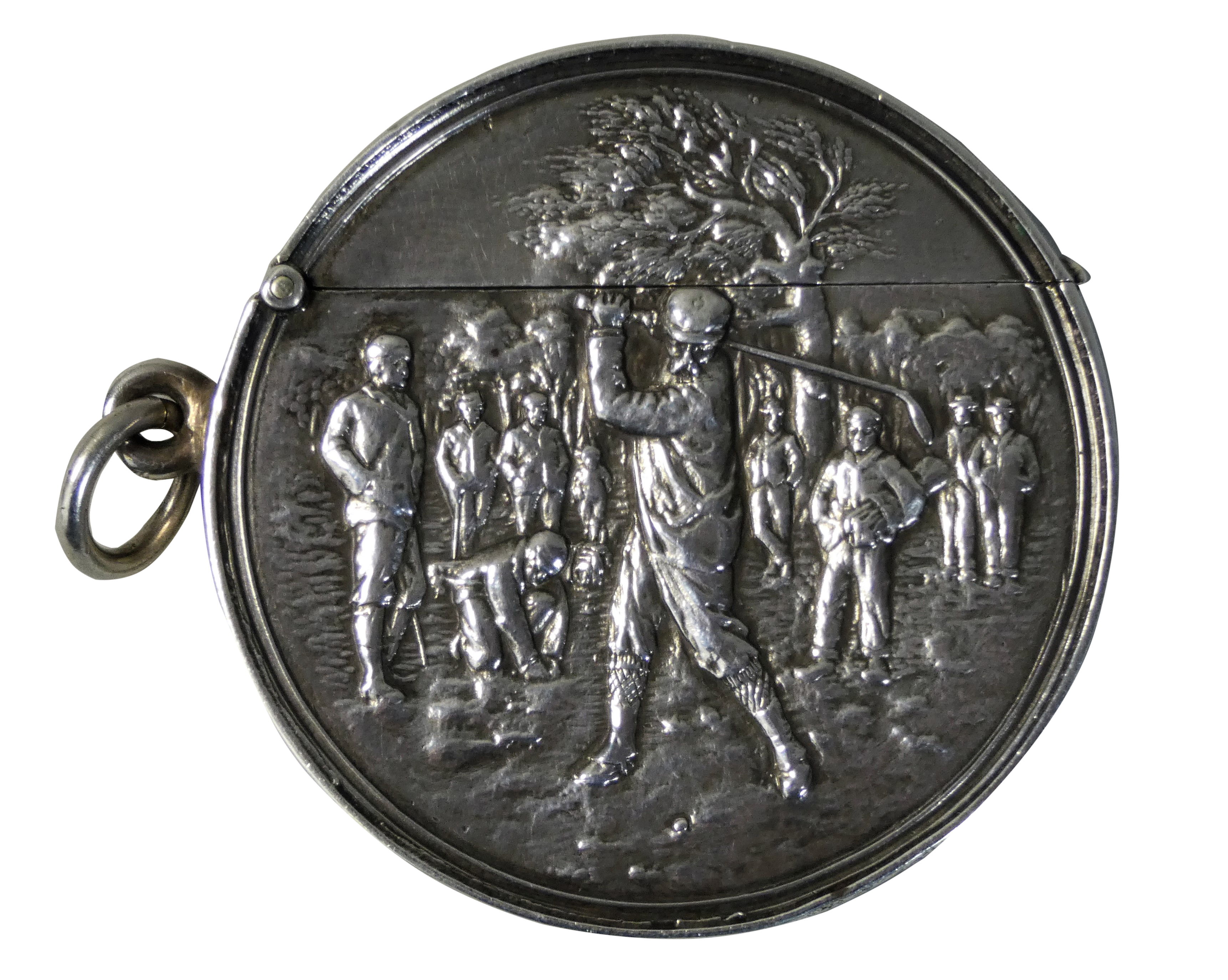 An Edwardian silver golfing vesta case, Birmingham 1906, of circular form, the central figure in