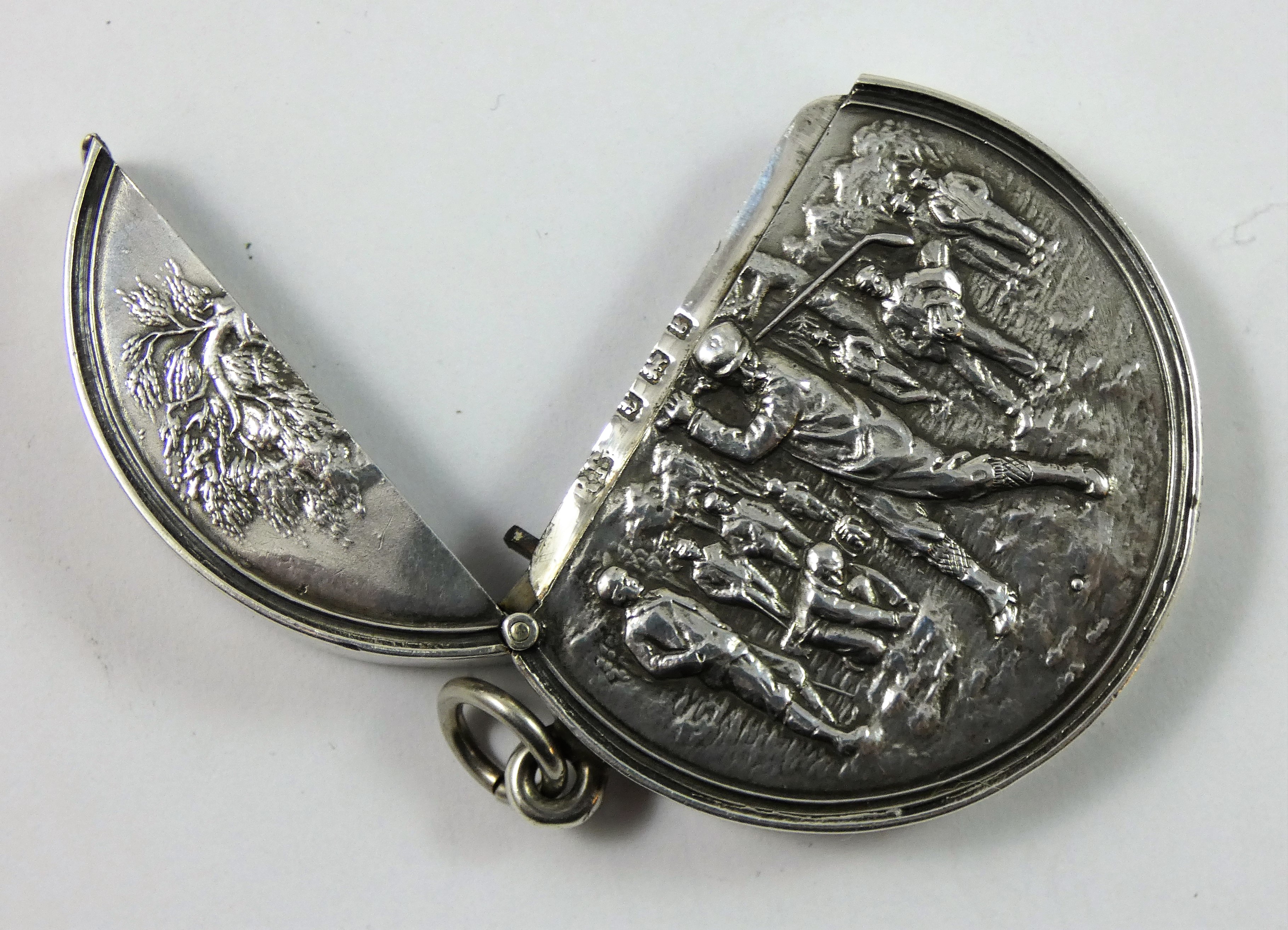 An Edwardian silver golfing vesta case, Birmingham 1906, of circular form, the central figure in - Image 2 of 3