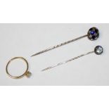 A Victorian gold, rose cut diamond and enamel stickpin, a paste set stick pin and a 9ct gold ring (