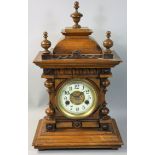 H. A. C. - a German fourteen day walnut mantle clock, the movement striking on a gong, numbered