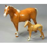 A Beswick Palamino horse, height 19cm, together with a Palamino mare, height 11.5cm, the mare with