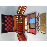 A Victorian rosewood and ebony strung games compendium, containing folding chess & backgammon board,