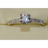 A platinum and diamond single stone diamond ring, claw set with a brilliant cut stone weighing
