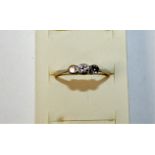 An 18ct gold three stone diamond ring, collet set with graduated old cut brilliant stone, weight