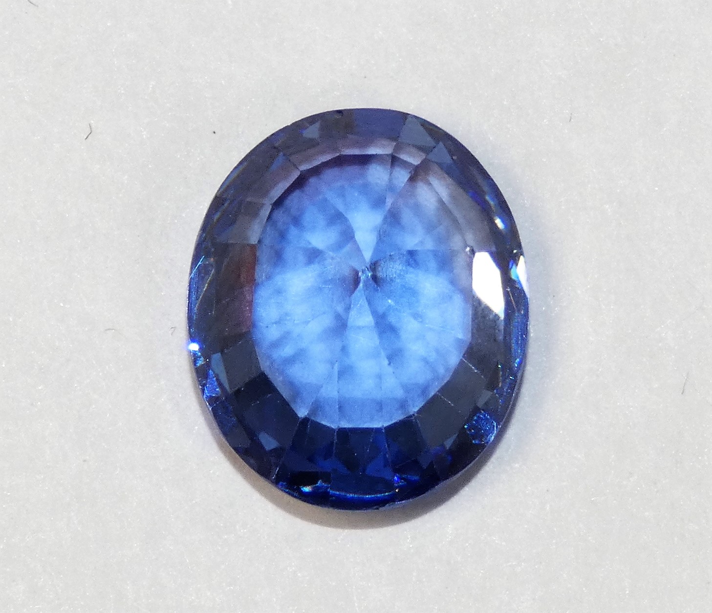 An oval mixed cut loose Tanzanite stone, 13 x 11 mm.