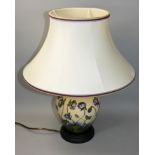 A Moorcroft 'Hepatica' pattern tube line decorated lamp with shade, of baluster shape with