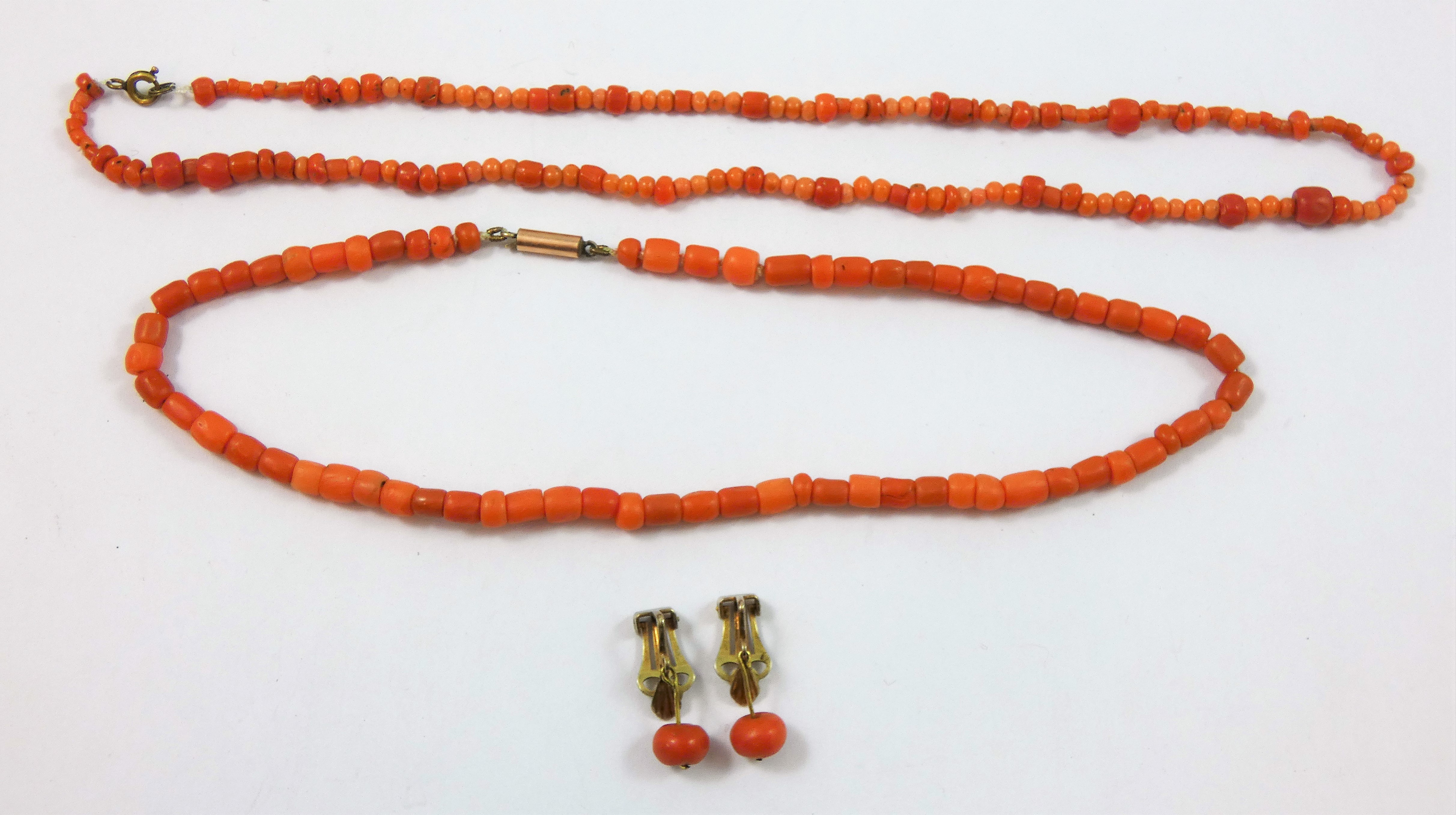 A Victorian coral bead single row necklace, another smaller and a pair of earrings, weight of