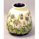 A Moorcroft 'Hibiscus' pattern tube line decorated vase, designed by Rachel Bishop, impressed