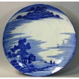 A large Chinese blue and white dish, depicting lake with two monk figures standing overlooking