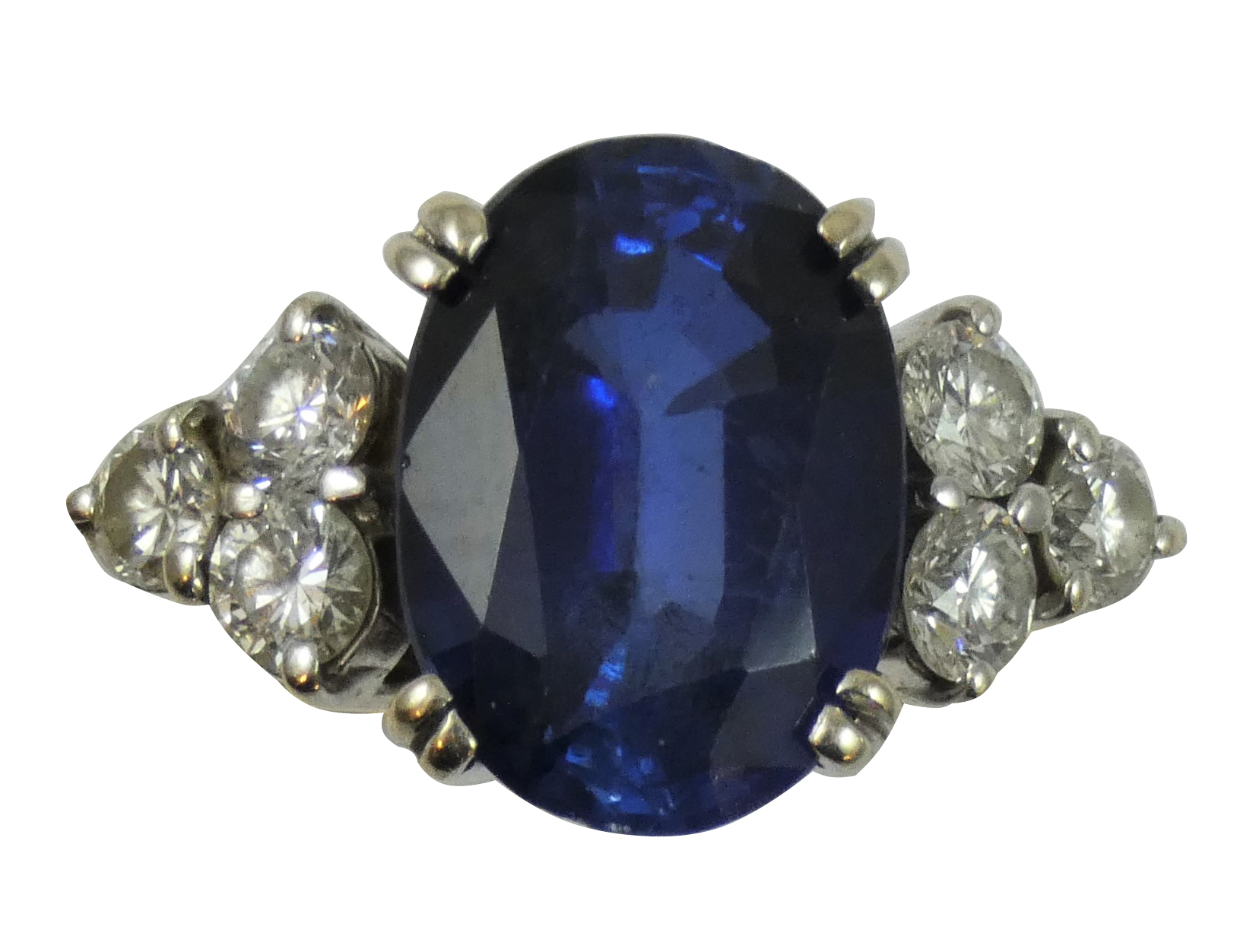 An 18ct white gold synthetic sapphire and diamond ring, claw set with an oval mixed cut stone,