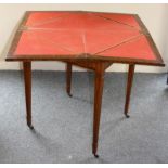 Maple & Co., an Edwardian burr walnut and boxwood inlaid envelope games table, the revolving top