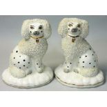 A pair of early 20th century flatback Staffordshire spaniel dogs, with rough coating finish,