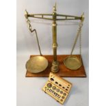 A set of Day & Millward brass and weighing scales on an oak base, overall height 53cm, together with