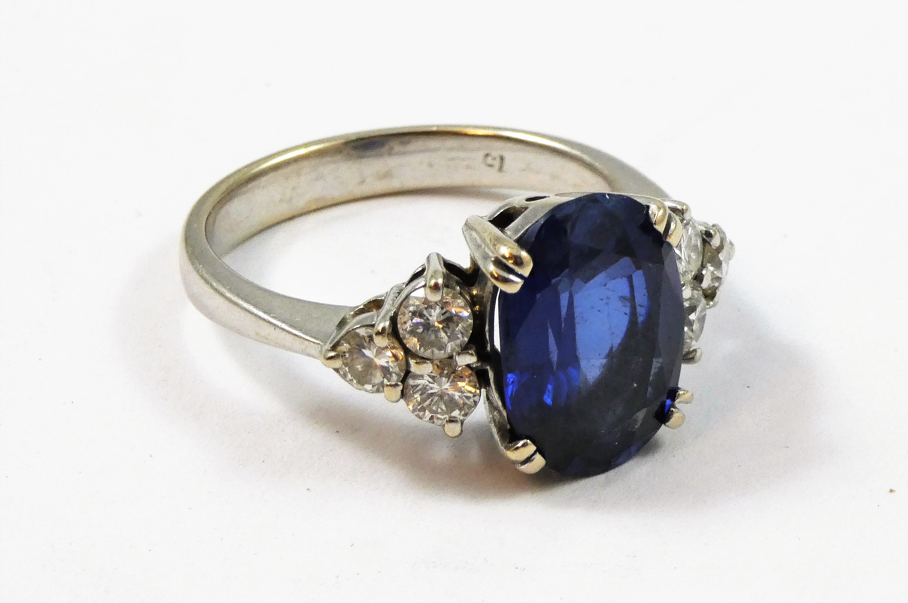 An 18ct white gold synthetic sapphire and diamond ring, claw set with an oval mixed cut stone, - Image 3 of 3