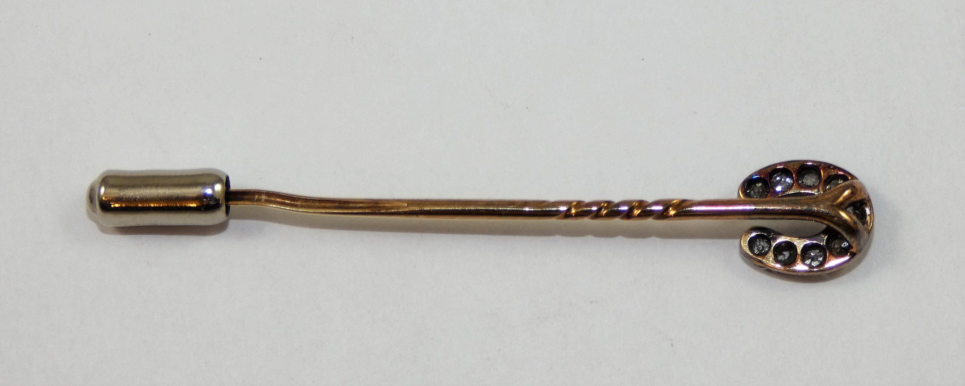 A Victorian diamond set horseshoe stickpin, silver set with nine old cut stones, total weight - Image 2 of 2