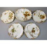 A French set of four Haviland & Co Limoges plates, with printed scenes and gilded scallop borders,