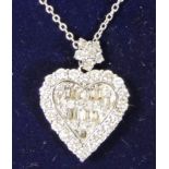 A diamond heart shape pendant, claw set with baguette and brilliant cut stones, total weight