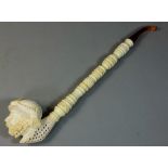 A Victorian style carved meerschaum long pipe, with bearded man terminal, case length 40cm.