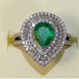 An 18ct white gold emerald and diamond pear shape ring, claw set with a mixed cut stone, weight 1.38