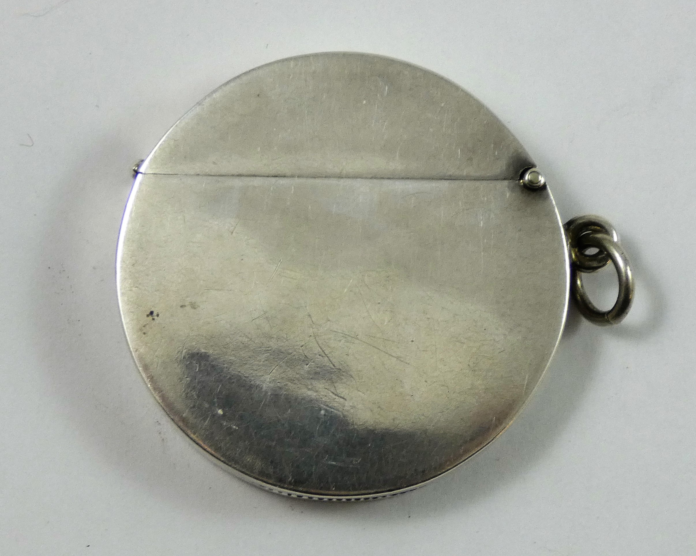 An Edwardian silver golfing vesta case, Birmingham 1906, of circular form, the central figure in - Image 3 of 3