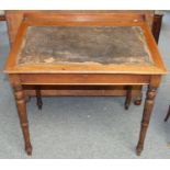 An Edwardian mahogany sloping writing desk, the hinged cover with leather insert, raised on turned