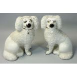 A pair of early 20th century flatback Staffordshire spaniel dogs, with rough coating finish, the