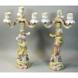 A pair of late 19th century German porcelain candelabra, three branch, the supports male and