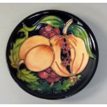 A Moorcroft 'Garnet Apple' pattern tube line decorated pin dish, designed by Rachel Bishop,