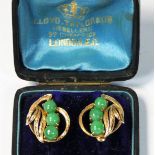 A 14K gold pair of jade ear rings, by J.A.W., composed of three cabochon stones with leaf