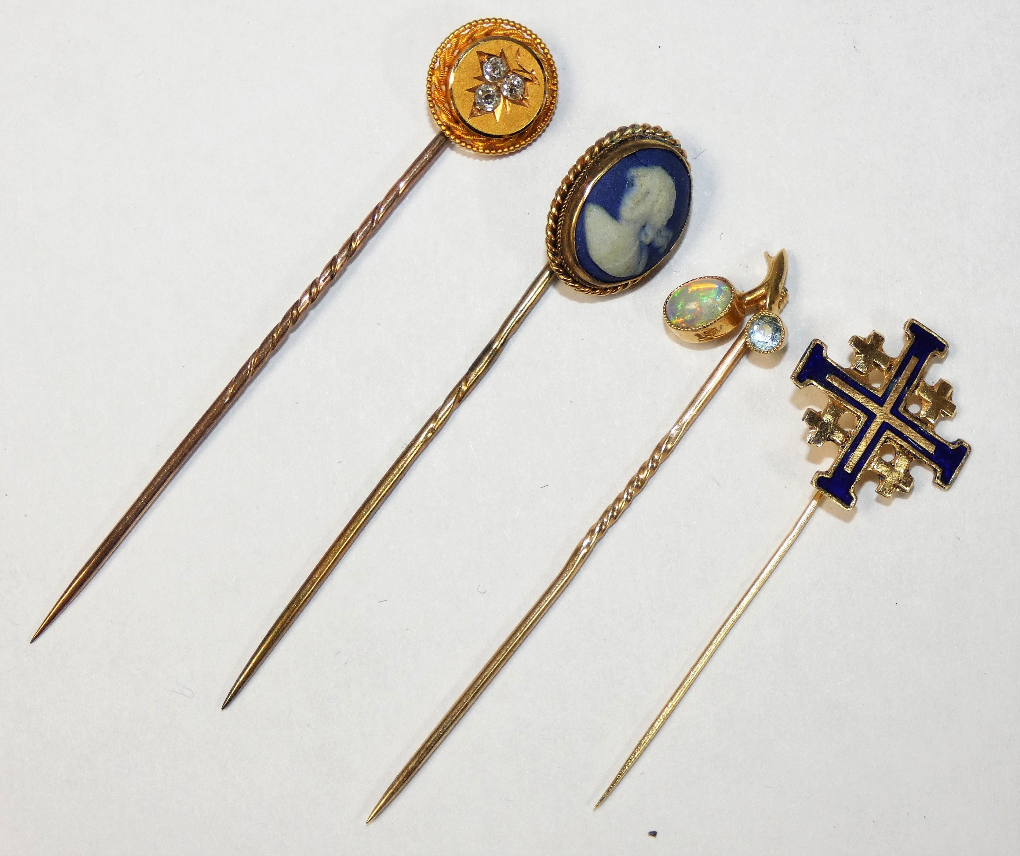 A Victorian gold stickpin inset with a diamond trefoil, an opal and aquamarine set stickpin, a