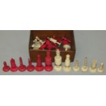 A late 19th/early 20th century Cantonese bone chess set, one side stained red, one knight a