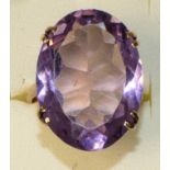 A 9ct rose gold mounted amethyst ring, four claw set with on oval mixed cut stone, 25 x 20 mm,