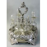 A Victorian EPBM six bottle oval cruet, the frame with grape and vine decoration, raised on four
