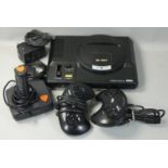 A Sega Mega Drive 16-Bit game console, together with a joystick, two control pads, AC mains