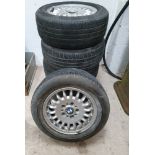 A set of five BMW alloy wheels, 7G x 15 part no 110069/1 with worn tyres